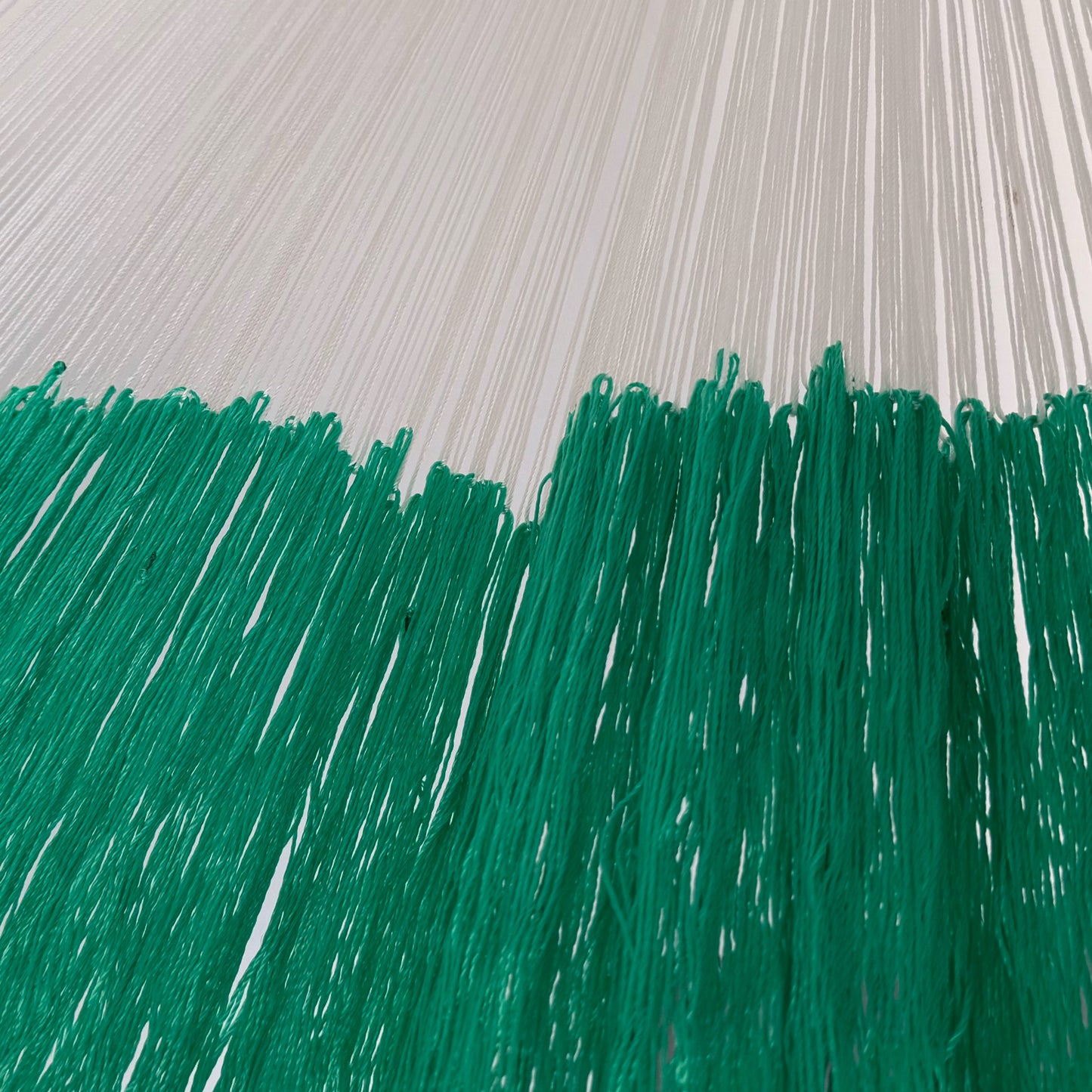 Unión entre cuerpo y brazo de hamaca artesanal Yucateca de nylon color verde