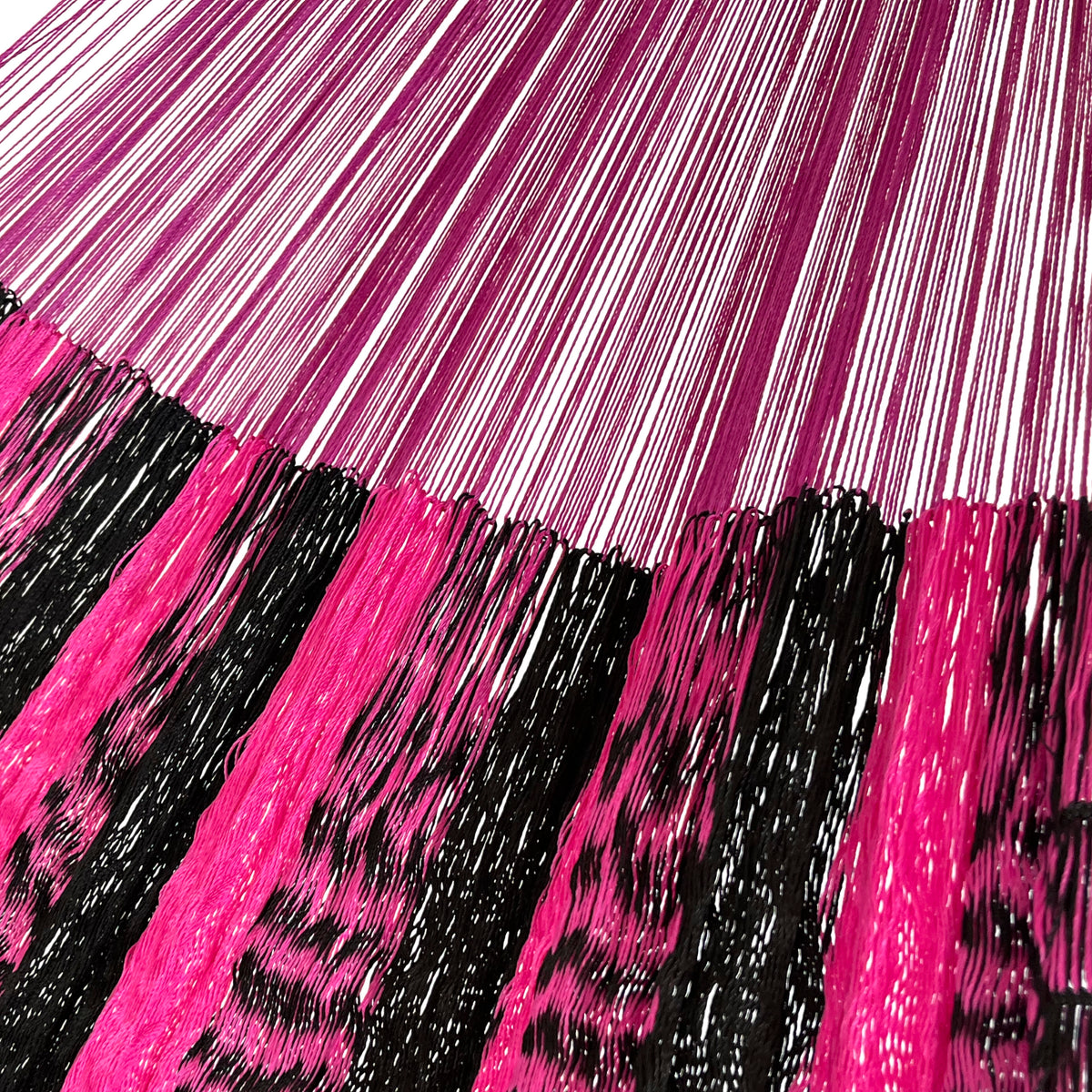 Detalle de la unión entre el cuerpo y el brazo de una hamaca yucateca artesanal de nylon suave rosa y negro
