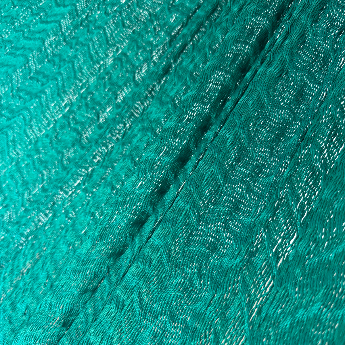 Detalle del tejido de nylon suave de la hamaca Yucateca artesanal verde oscuro.