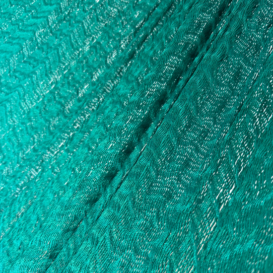 Detalle del tejido de nylon suave de la hamaca Yucateca artesanal verde oscuro.
