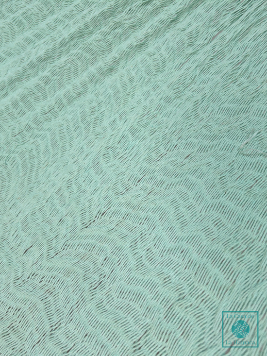 Detalle del tejido de algodón suave de la hamaca Yucateca artesanal color turquesa